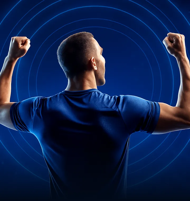 Football fan in a blue shirt raising both fists in celebration against glowing blue rings, promoting an MD88 bonus